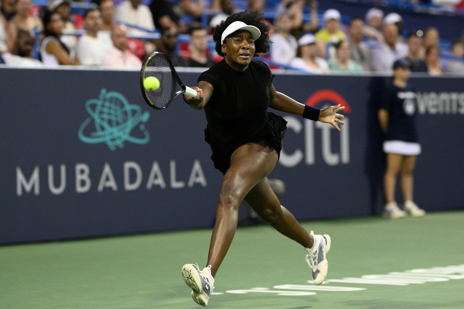 Venus Williams returns the ball against Peyton Stearns during a match at the Citi Open tennis tournament Tuesday, July 22, 2025, in Washington. (AP Photo/Nick Wass)