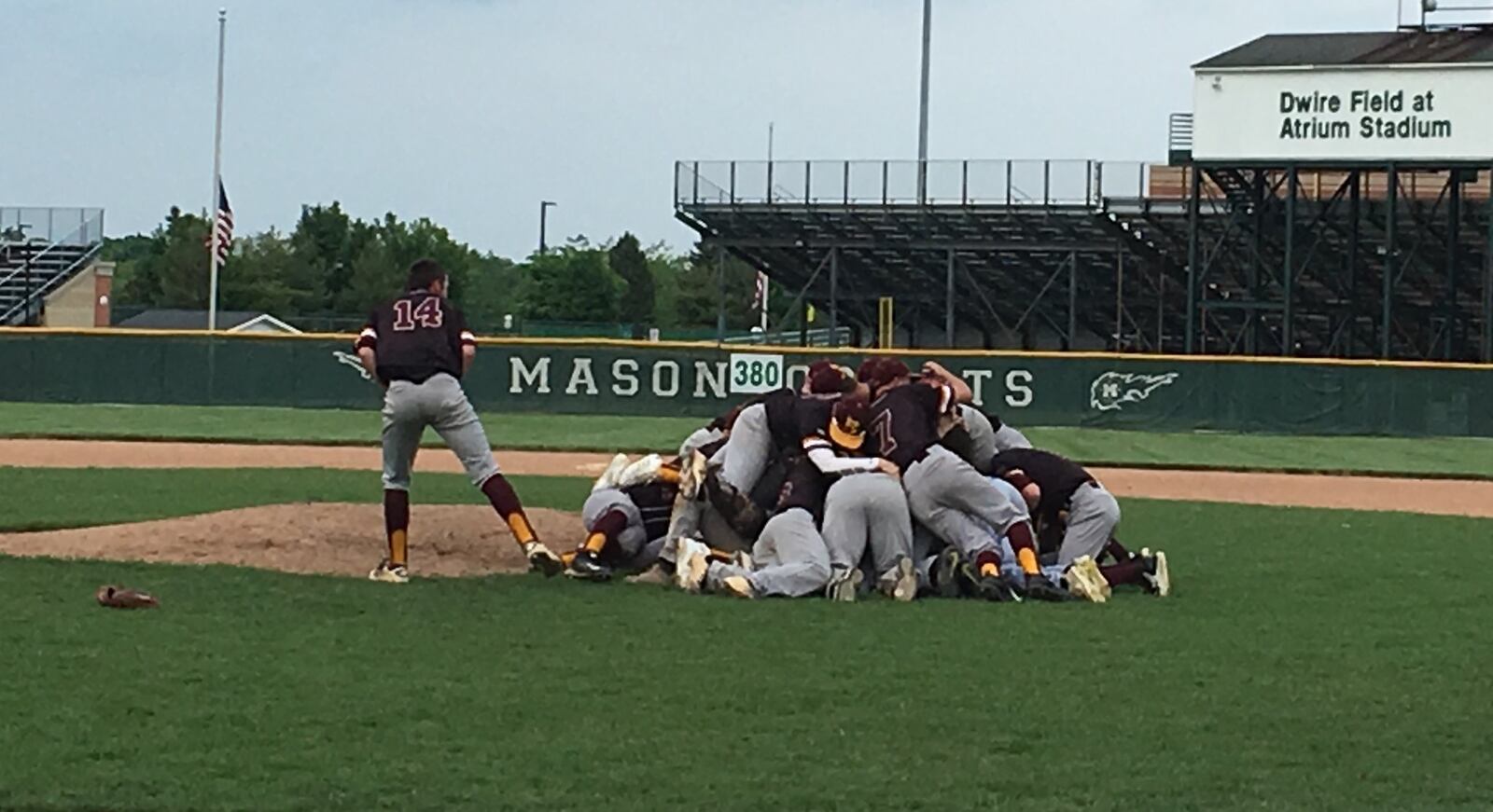 Keegan Nickoson (14) has a great view of his Ross teammates’ celebration dogpile at Mason on Monday after the Rams defeated Tippecanoe 6-3 to repeat as Division II district champions. RICK CASSANO/STAFF