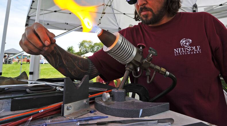 NEW ARTLINE FOR 2019: Justin Davis with Neusole Glassworks heats glass during a live demo at the 2018 Middletown Arts Festival. The event returns for its sixth year Sept. 14 on Central Avenue. NICK GRAHAM/STAFF ORIGINAL ARTLINE: Justin Davis with Neusole Glassworks heats glass during a live demo at the Middletown Arts Festival Sunday, Sept. 16 in Middletown. Painters, glass artists, woodworkers, musicians, food vendors and more gathered in downtown Middletown for the event. NICK GRAHAM/STAFF