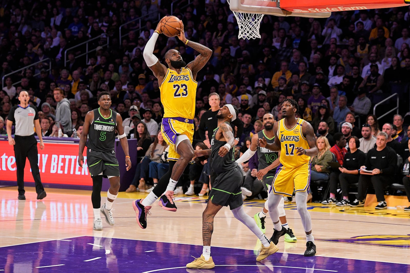 FILE - Los Angeles Lakers forward LeBron James (23) shoots as Minnesota Timberwolves guard Nickeil Alexander-Walker (9) defends during the first half in Game 5 of an NBA basketball first-round playoff series Wednesday, April 30, 2025, in Los Angeles. (AP Photo/Mark J. Terrill, File)