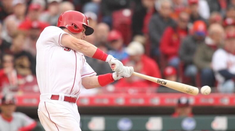 The Reds’ Scooter Gennett swings against the Nationals on Opening Day on Friday, March 30, 2018, at Great American Ball Park in Cincinnati. David Jablonski/Staff