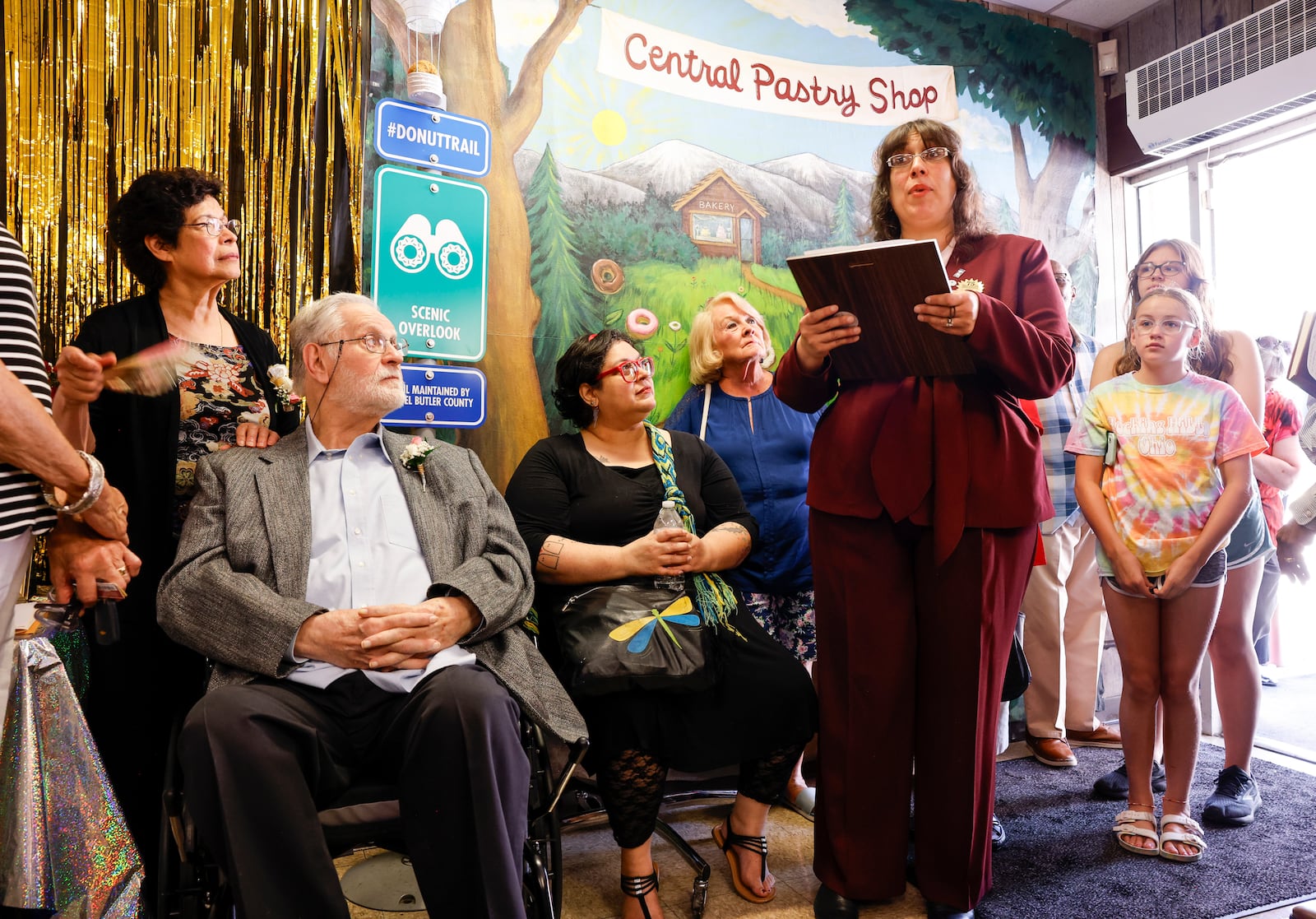 Middletown Mayor Elizabeth Slamka reads a proclamation as Central Pastry celebrated their 75th anniversary Wednesday, Aug. 14, 2024 with family, friends and customers gathering for ribbon cutting and delicious treats. Vera and John Slamka have owned the business for 40 years. NICK GRAHAM/STAFF