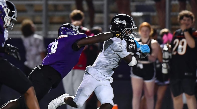 Middletown's C.J. Bryant looks to make a tackle against Lakota East's Carter Jones earlier this season. KYLE HENDRIX / CONTRIBUTED