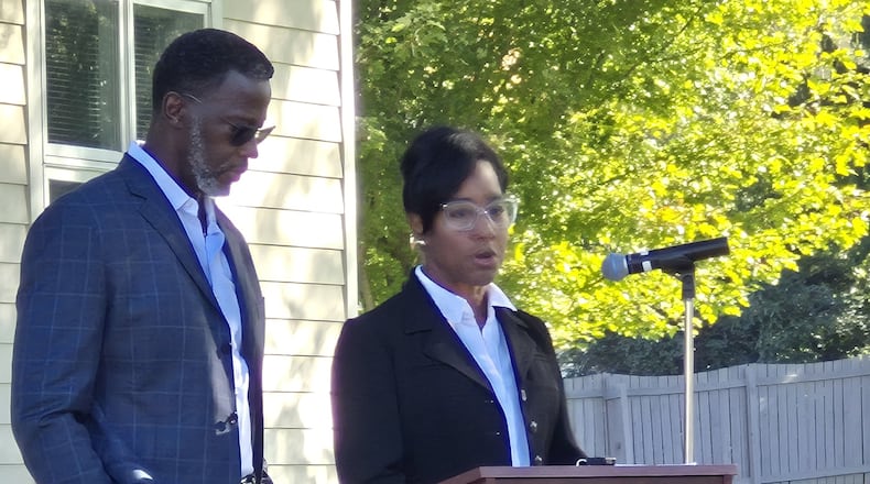University of Dayton men's basketball coach Anthony Grant and his wife, Chris, address representatives of area colleges and health care networks Friday during the launch of a collaboration to provide mental health services to college students. MICHAEL KURTZ / STAFF