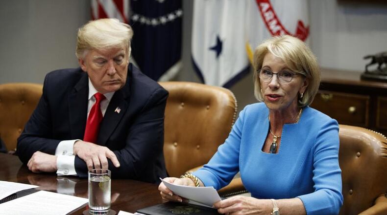 U.S. Education Secretary Betsy DeVos and President Donald Trump. Getty Image