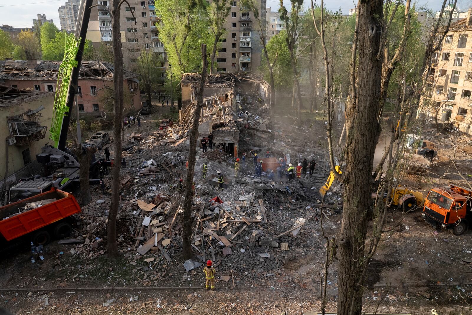Rescue workers clear the rubble after a Russian strike in a residential neighborhood in Kyiv, Ukraine, Thursday, April 24, 2025. (AP Photo/Alex Babenko)