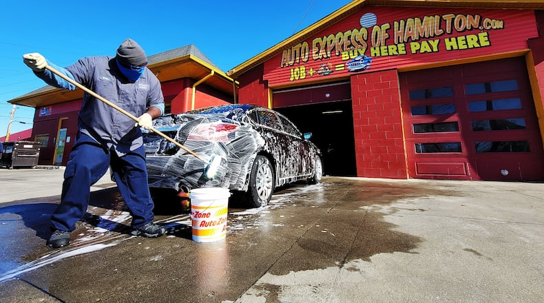 Walton Lumpkin washes a car at Auto Express of Hamilton Friday, Nov. 23, 2020 on Dixie Highway in Hamilton. NICK GRAHAM / STAFF