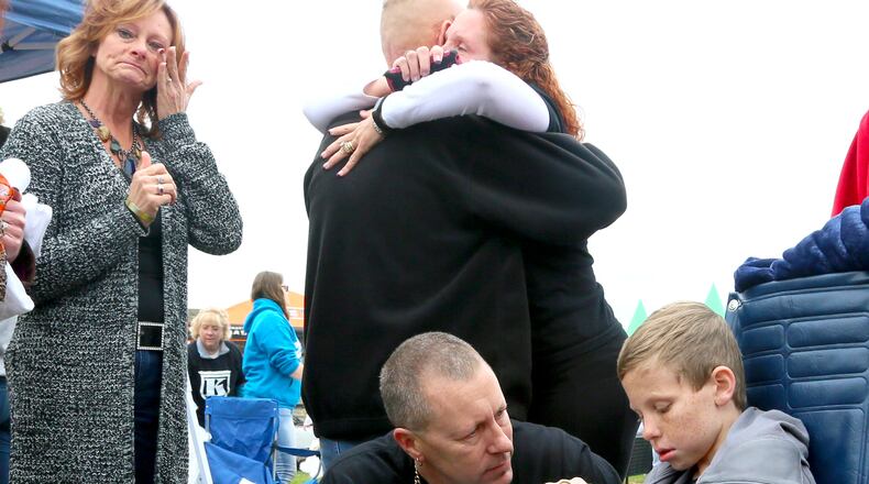 Kirk Bradley talks with his son, Kyler Bradley, during a fundraiser in October. Kyler has DIPG, an inoperable brain cancer that attacks brain stems and nervous system functions. GREG LYNCH / STAFF