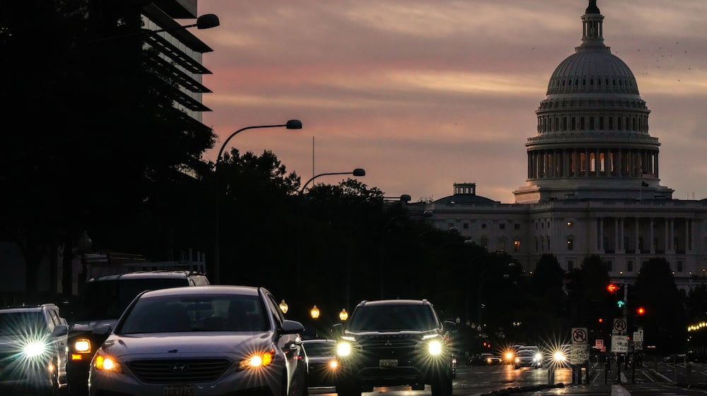 FILE - Vehicles drive along Pennsylvania Ave. during rush hour traffic at sunrise Wednesday, Oct. 1, 2025, in Washington, with the U.S. Capitol in the background. (AP Photo/Julia Demaree Nikhinson, File)