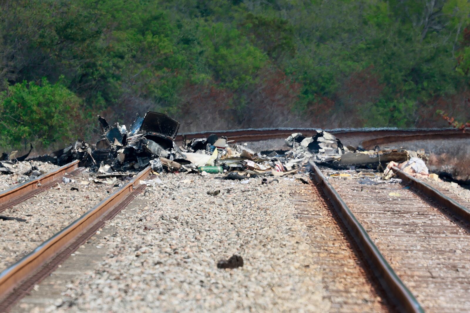 Emergency personnel respond to the area where a small plane crashed on the railroad tracks beneath the overpass near Interstate 95 in Boca Raton, Fla., on Friday, April 11, 2025. (Mike Stocker /South Florida Sun-Sentinel via AP)