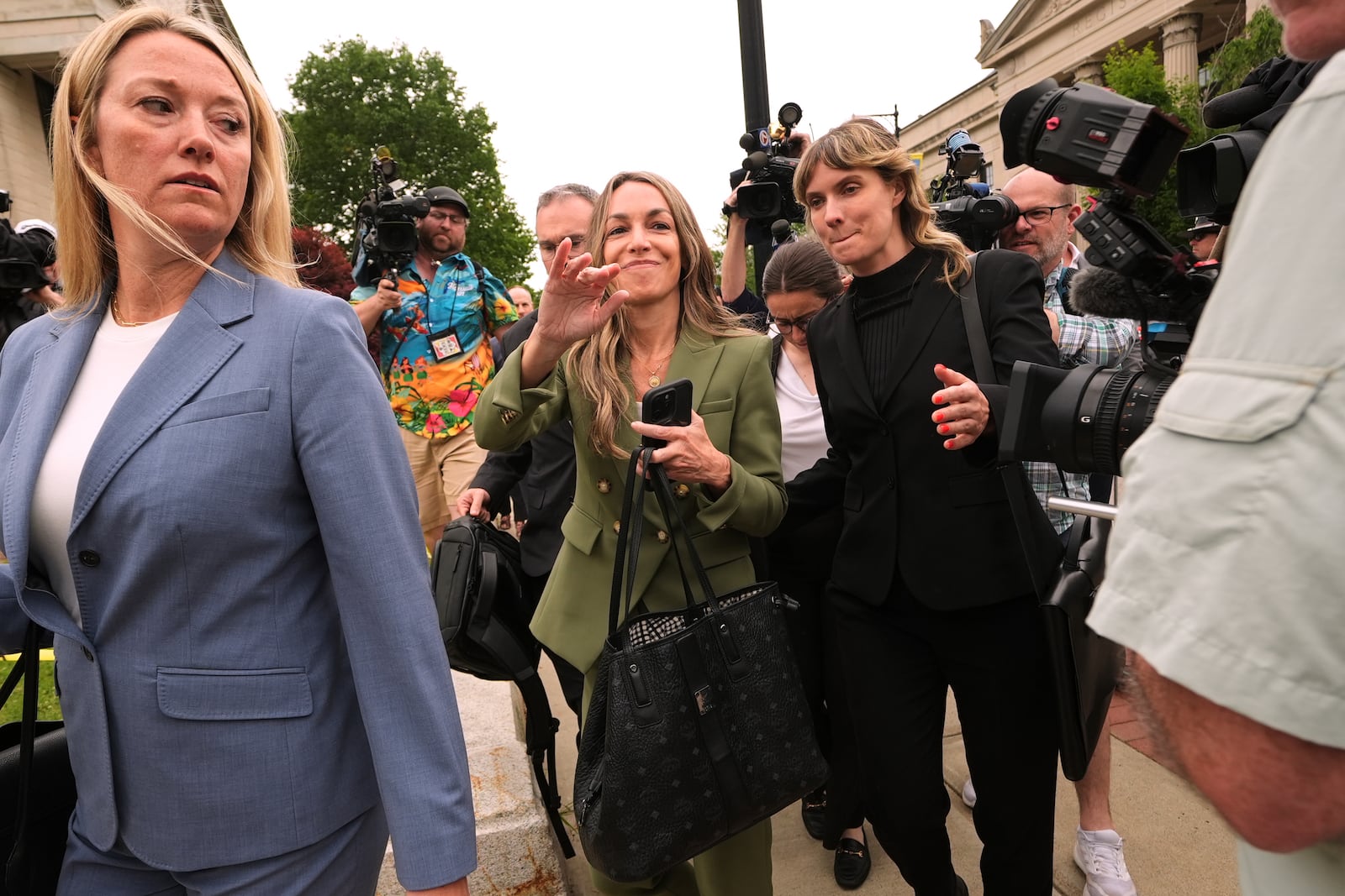 Karen Read gestures to her supporters while departing Norfolk Superior Court during jury deliberations at her trial, Tuesday, June 17, 2025, in Dedham, Mass. (AP Photo/Charles Krupa)