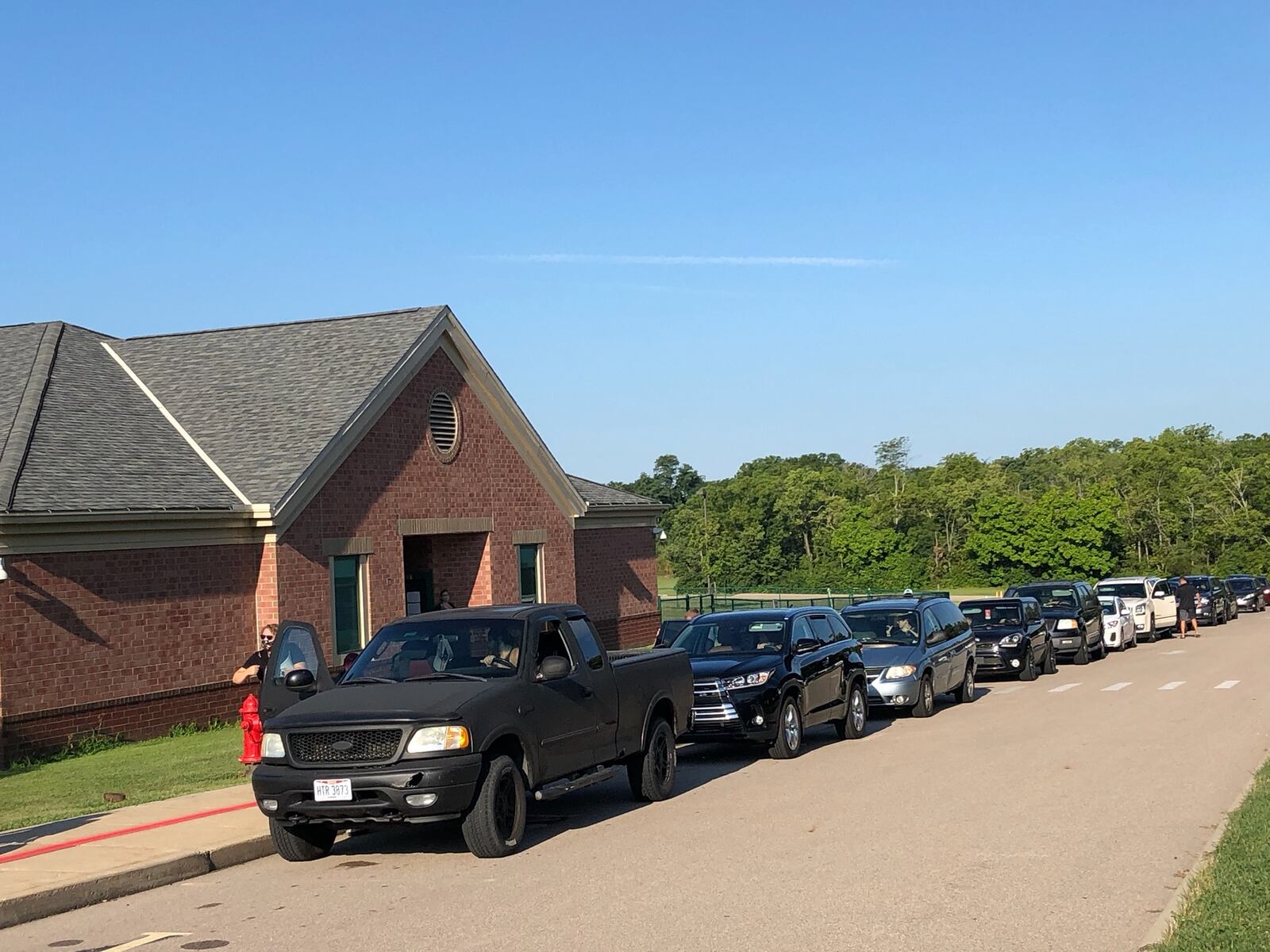 A long line of parents wait to drop off their students on the first day of school in the Lebanon school district.