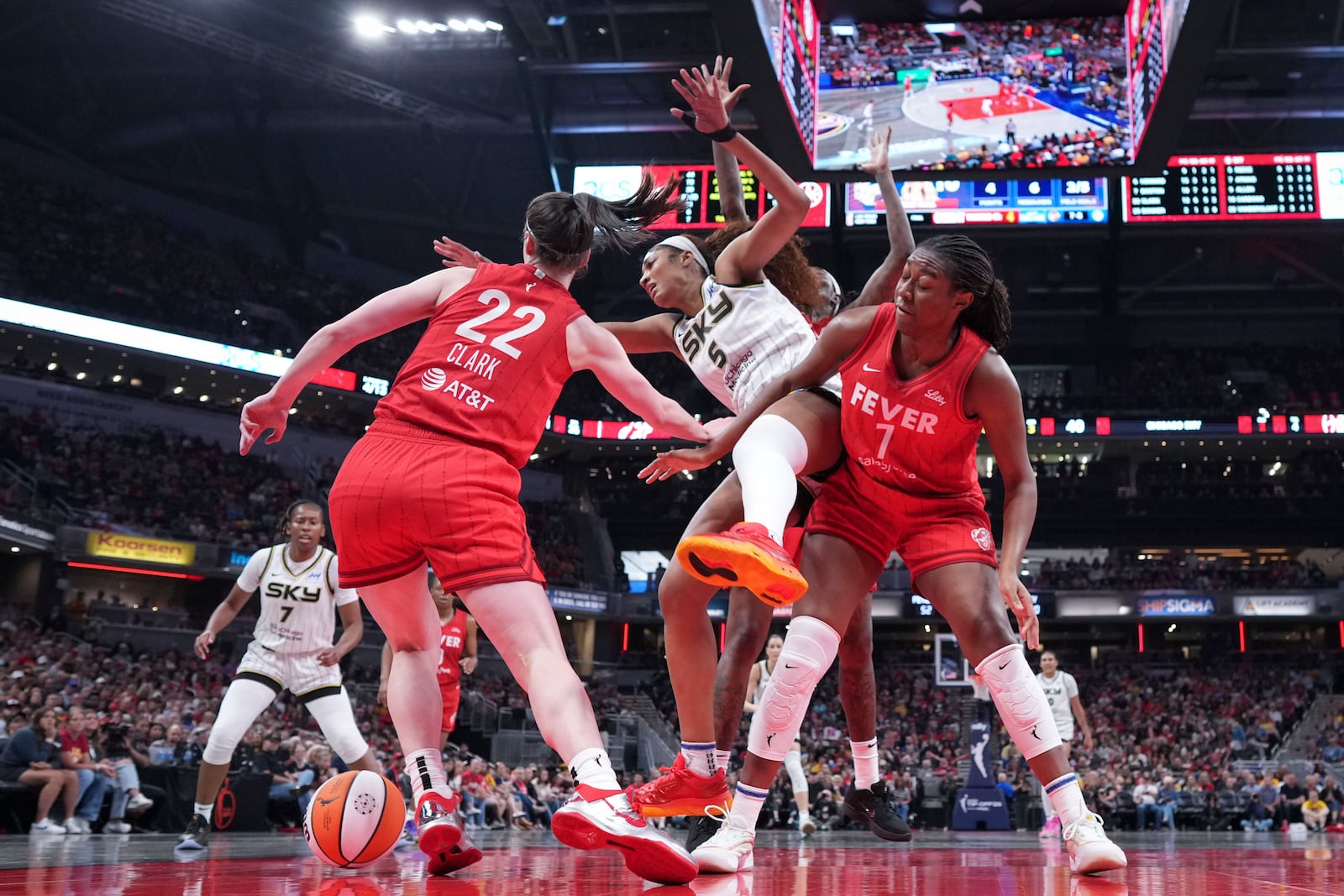 Indiana Fever guard Caitlin Clark, left, fouls Chicago Sky forward Angel Reese, center, during the second half an WNBA basketball game in Indianapolis, Saturday, May 17, 2025. (AP Photo/AJ Mast)