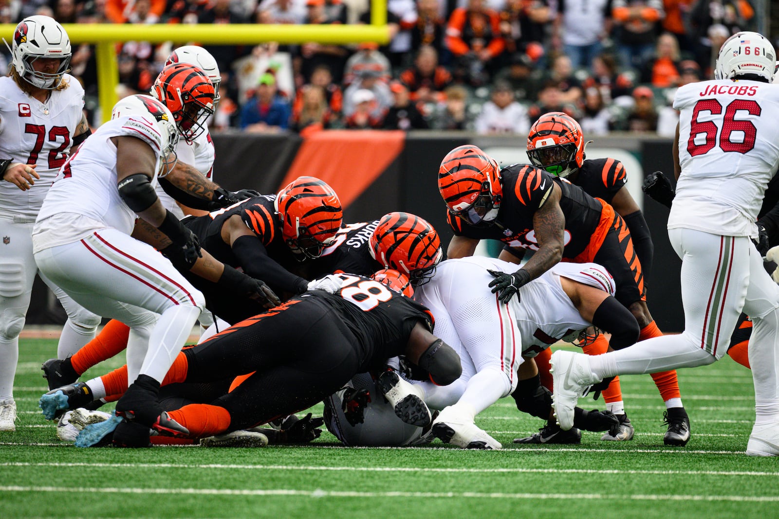Bengals defenders make a tackle in the first quarter of their game against the Arizona Cardinals on Sunday, Dec. 28 at Paycor Stadium. JEREMY MILLER / CONTRIBUTED PHOTO