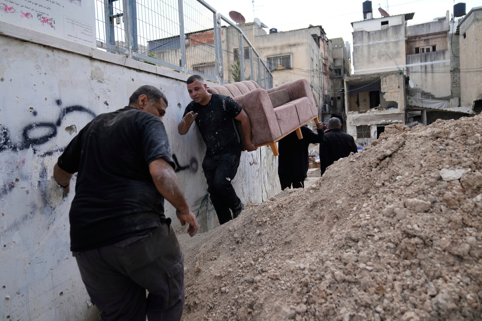 Residents of the now evacuated refugee camp of Tulkarem return to collect belongings before the destruction of their homes as Israeli forces prepare to carry out the demolition of 116 homes across the two refugee camps of the Israeli occupied West Bank city of Tulkarem, Friday, May 2, 2025. (AP Photo/Nasser Nasser)