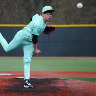 Badin senior Beau Chaney sends a pitch to the plate during the Rams' 7-0 loss against Toledo St. Francis de Sales on Friday afternoon at Xenia's Athletes in Action. CHRIS VOGT / CONTRIBUTED