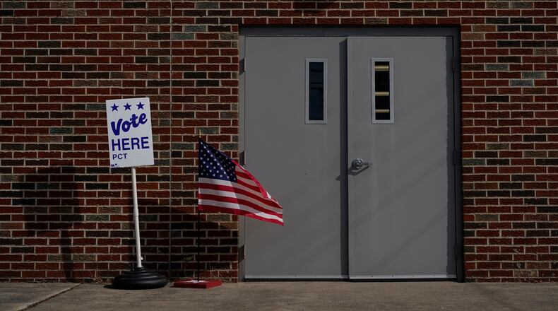 The door of the Jeffersonville Masonic Lodge polling location is marked with an American Flag and a "Vote Here" sign on Election Day in Jeffersonville, Ohio, Tuesday, Nov. 7, 2023. Polls are open in a few states for off-year elections that could give hints of voter sentiment ahead of next year's critical presidential contest. (AP Photo/Carolyn Kaster)