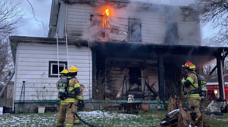 Franklin firefighters battle a blaze at a two-story home on Wilson Avenue Tuesday afternoon. An elderly resident was removed from the house and a firefighter was injured. CONTRIBUTED/FRANKLIN DIVISION OF FIRE