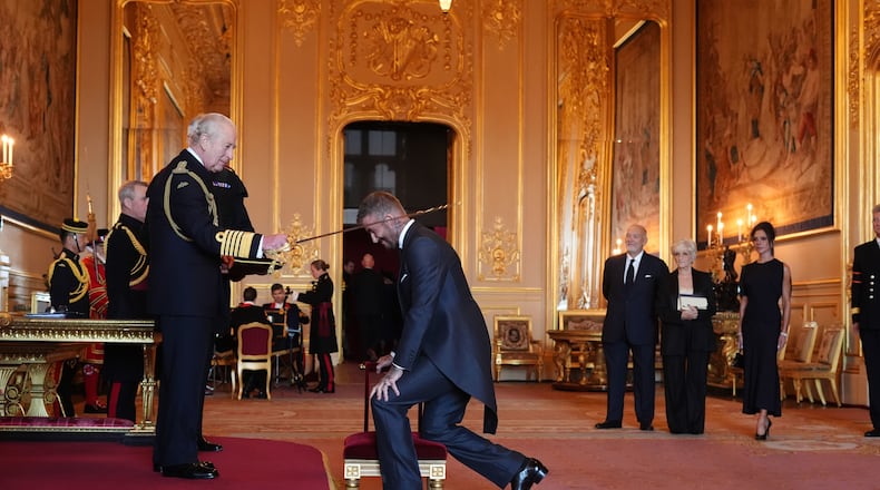 Sir David Beckham is made a Knight Bachelor by Britain's King Charles III during an Investiture ceremony at Windsor Castle, Berkshire, England, Tuesday, Nov. 4, 2025. (Jonathan Brady/PA via AP)