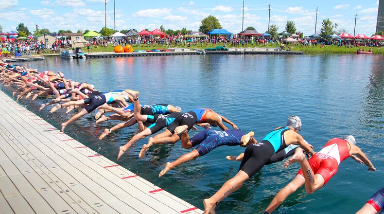 In this 2015 file photo, athletes compete in the USA Triathlon Youth and Junior National Championship at Voice of America MetroPark in West Chester Twp. Parts of Cox Road and Liberty Way, as well as VOA Park, will be closed Saturday and Sunday, Aug. 5-6, to accommodate the event. GREG LYNCH/2015