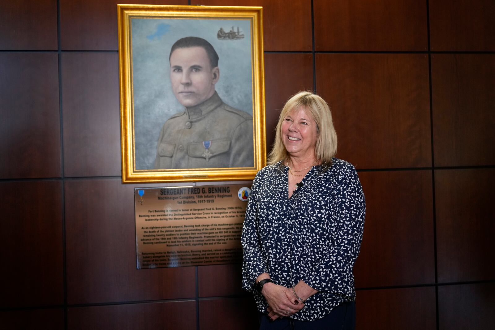 Ms. Sue Conger-Williams, Fred Benning's granddaughter gives and interview in front of her grandfathers portrait hanging at Fort Benning during a ceremony honoring new namesake on Wednesday, April 16, 2025, in Fort Benning, Ga. (AP Photo/Brynn Anderson)