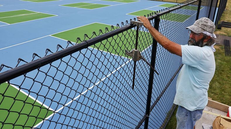 Mark Gilbert, with Ashlee Fence, installs fence around nine new picklball courts at Lefferson Park Monday, June 17, 2024 in Middletown. NICK GRAHAM/STAFF