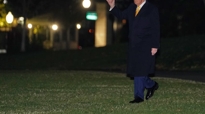 President Donald Trump waves as he walks to board Marine One, Friday, Nov. 14, 2025, on the South Lawn of the White House, in Washington for a trip to Palm Beach, Fla. (AP Photo/Allison Robbert)