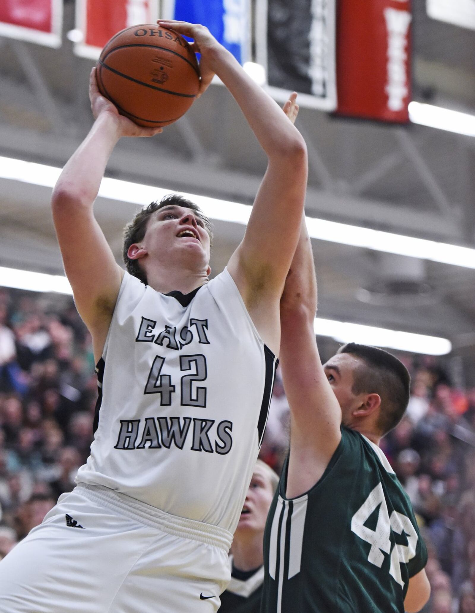 Lakota East’s Alex White drives to the hoop over Mason’s Rodney Hutchison during a game Feb. 20, 2015, in Liberty Township. East won 63-62 in overtime. NICK GRAHAM/STAFF