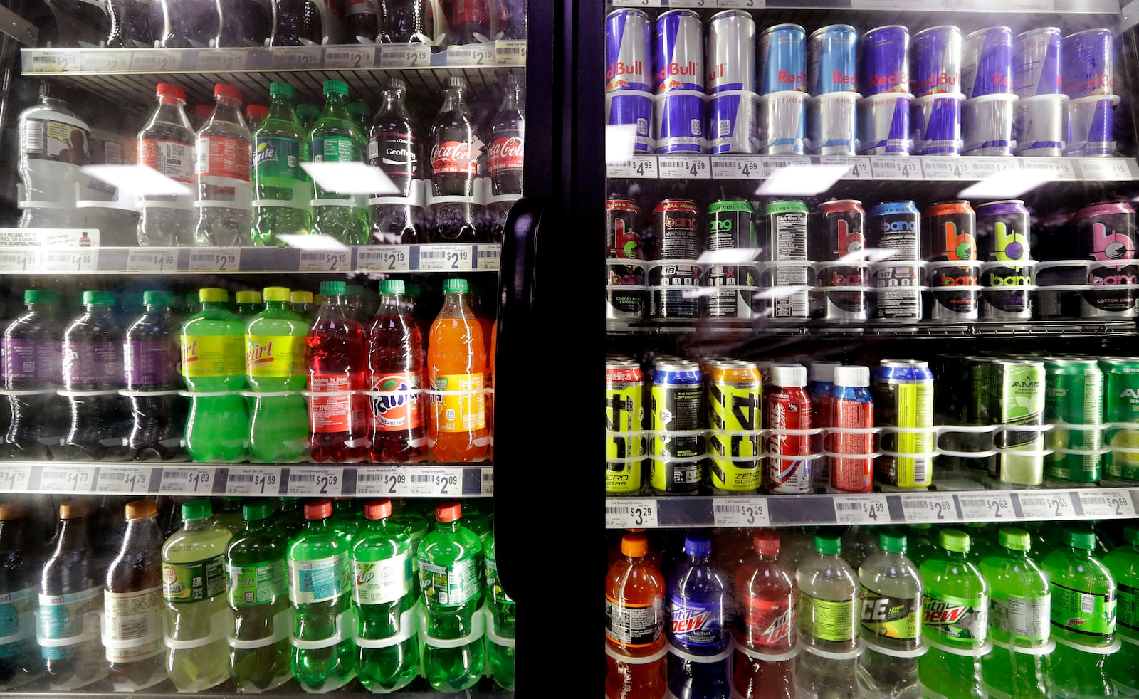 FILE - Soft drinks fill a drink cooler in a convenience store in Kent, Wash., Oct. 1, 2018. (AP Photo/Elaine Thompson, File)