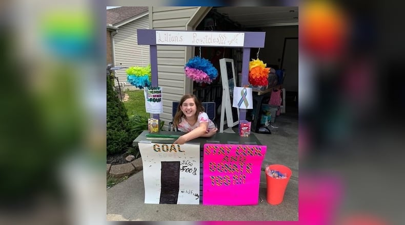 Lilian Moore, 11, of Trenton, raised more than $6,000 during her three-day Popsicle Stand sale during the city’s annual garage sale. She donated the money to help people with stage IV breast cancer. CONTRIBUTED
