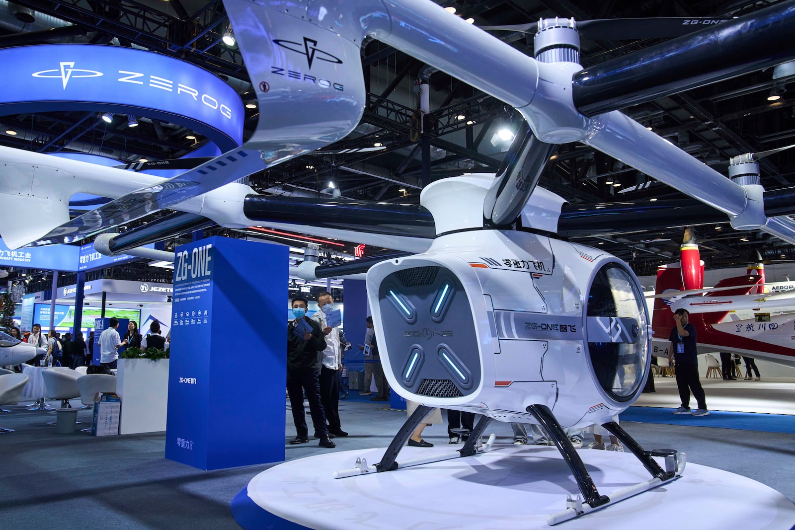 Visitors tour the ZEROG booth showcasing it ZG-ONE, a two-seated eVTOL multicopter aircraft with its autonomous piloting at the 3rd Exhibition of Technology and Education in Civil Aviation as China promoting the low-altitude economy, in Beijing, Tuesday, May 27, 2025. (AP Photo/Andy Wong)
