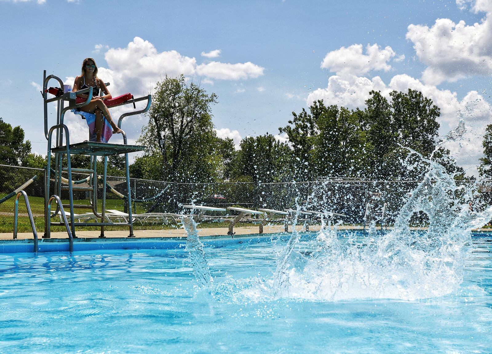 Lifeguard Kristen Parker watches swimmers at the pool at Wildwood Golf Club in Middletown. NICK GRAHAM / STAFF