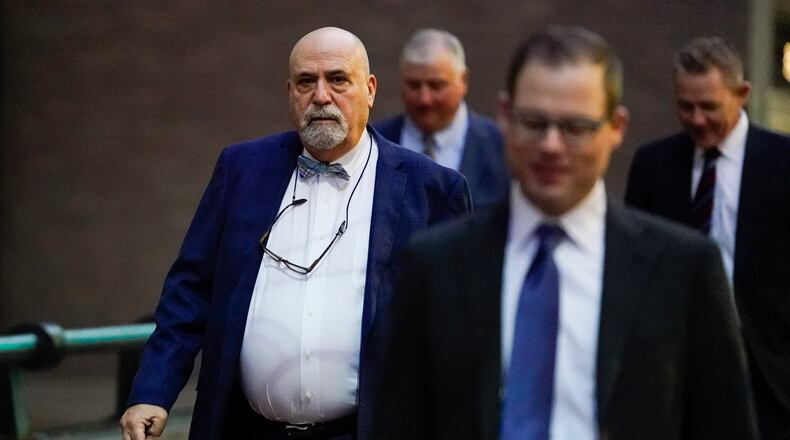 Defense attorney Mark Marein, left, walks toward Potter Stewart U.S. Courthouse before jury selection in the federal trial of former Ohio House Speaker Larry Householder, Friday, Jan. 20, 2023, in Cincinnati. Householder and former Ohio Republican Party chair Matt Borges are charged with racketeering in an alleged $60 million scheme to pass state legislation to secure a $1 billion bailout for two nuclear power plants owned by Akron, Ohio-based FirstEnergy. Householder and Borges have both pleaded not guilty. (AP Photo/Joshua A. Bickel)