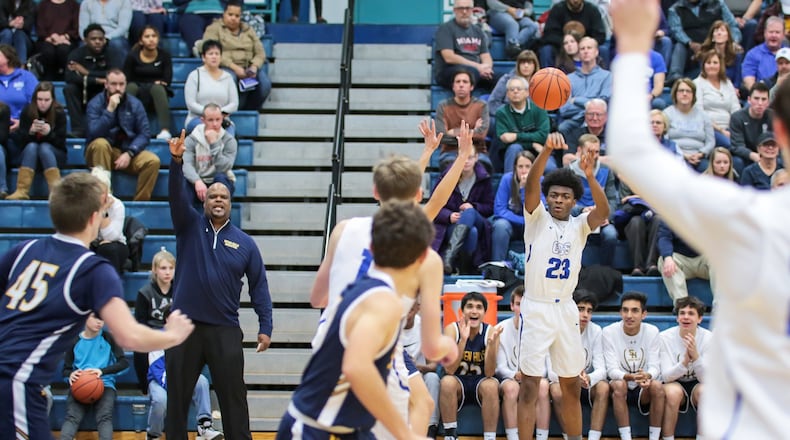 Cincinnati Christian’s Cameron Rogers (23) makes an entry pass during Friday night’s game against Seven Hills in Fairfield Township. The visiting Stingers won 45-40. PHOTO BY KRAE/WWW.KRAEPHOTOGRAPHY.COM