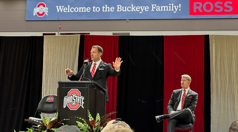 Ross Bjork speaks while Ted Carter (seated) looks on during a press conference to introduce Bjork as Ohio State's next director of athletics Jan. 17, 2024.