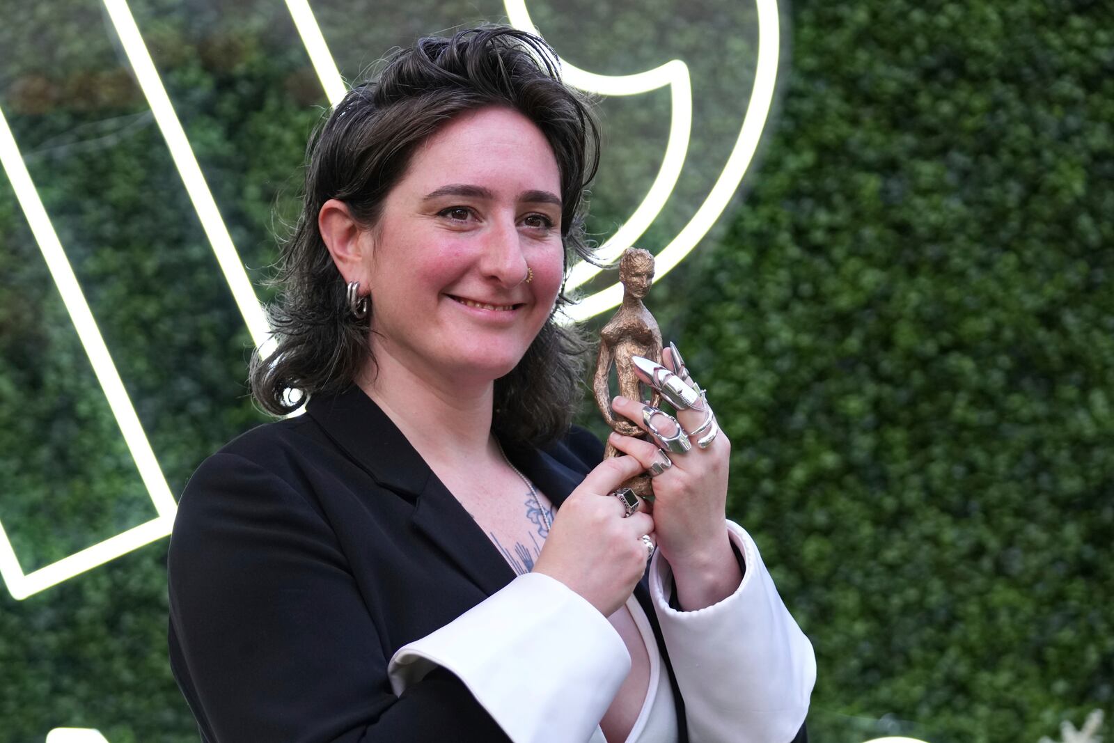 Winner of the Women's Prize for Non Fiction Yael van Der Wouden, who wrote 'The Safekeep' holds her trophy as she poses for the media in London, Thursday, June 12, 2025. (AP Photo/Joanna Chan)