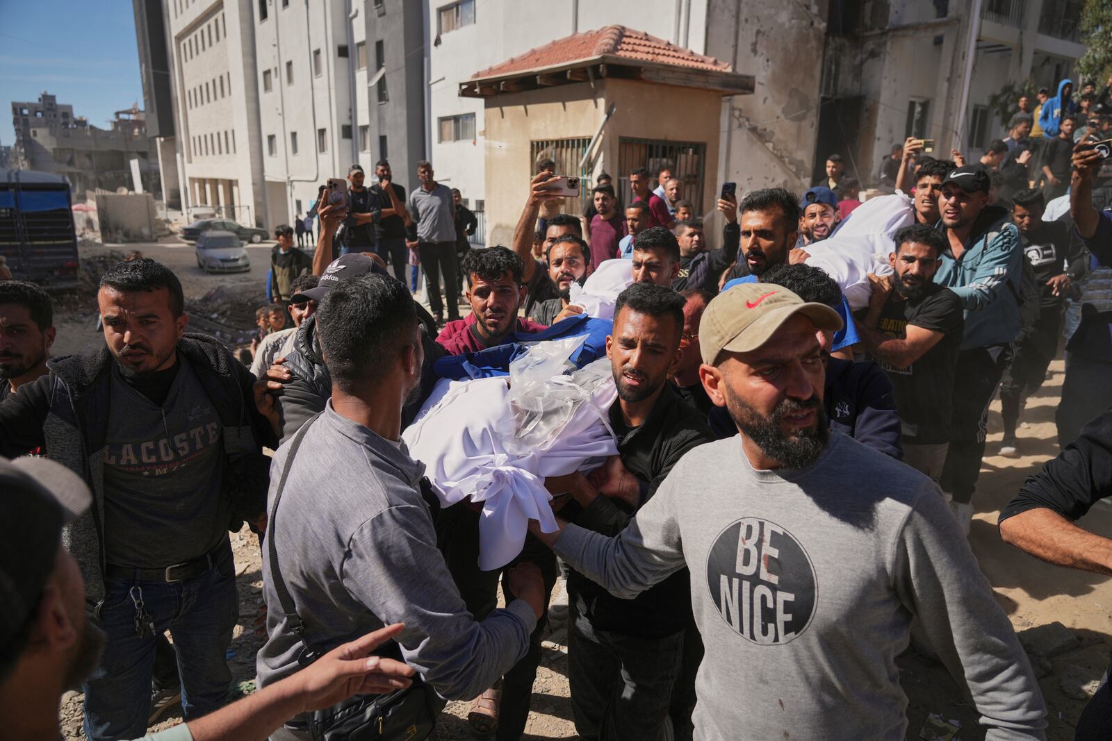The body of Palestinian journalist Yahya Sobeih, center, who was killed along with at least 28 others in an Israeli army strike on a restaurant, is carried at Shifa hospital in Gaza City, Wednesday, May 7, 2025.