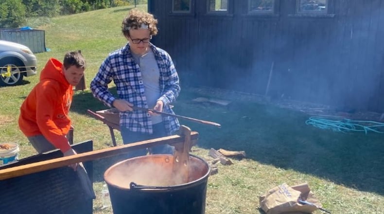 Volunteers help with a live demonstration of apple butter kettle cooking at the 57th Apple Butter Festival Oct. 2, 2022 at the Doty Homestead at Hueston Woods State Park. TAJ SIMMONS/CONTRIBUTED