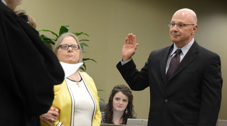 Fairfield City Council member Mark Scharringhausen takes his oath of office on Monday, March 9, 2020. He was appointed to fill the remaining term of the late Council member Ron D’Epifanio, who died on Jan. 21 with two years remaining on his term. Also pictured is Fairfield Municipal Judge Joyce Campbell (administering the oath) with D’Epifanio’s daughter, Lynne. MICHAEL D. PITMAN/STAFF