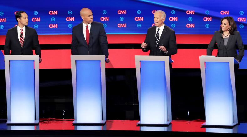 DETROIT, MICHIGAN - JULY 31: Democratic presidential candidate former Vice President Joe Biden (2nd R) speaks while Sen. Kamala Harris (D-CA) (R), Sen. Cory Booker (D-NJ) and former housing secretary Julian Castro listen during the Democratic Presidential Debate at the Fox Theatre July 31, 2019 in Detroit, Michigan. 20 Democratic presidential candidates were split into two groups of 10 to take part in the debate sponsored by CNN held over two nights at Detroits Fox Theatre. (Photo by Scott Olson/Getty Images)