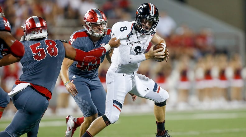 OXFORD, OH - SEPTEMBER 16: Doug Costin #58 and Pasquale Calcagno #92 of the Miami Ohio Redhawks sacks Hayden Moore #8 of the Cincinnati Bearcats during the first half at Yager Stadium on September 16, 2017 in Oxford, Ohio. (Photo by Michael Reaves/Getty Images)