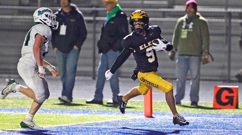 Centerville's Ryan Swanson carries the ball into the endzone for an Elks touchdown during Friday's playoff game at Springfield. BILL LACKEY/STAFF