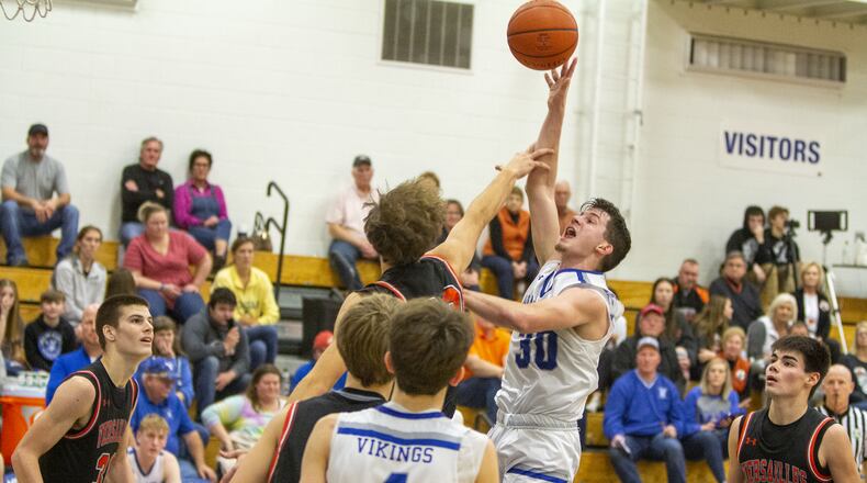 Miami East junior Jacob Roeth is fouled during Friday night's home victory over Versailles. Roeth scored his 1,000th point. CONTRIBUTED/Jeff Gilbert