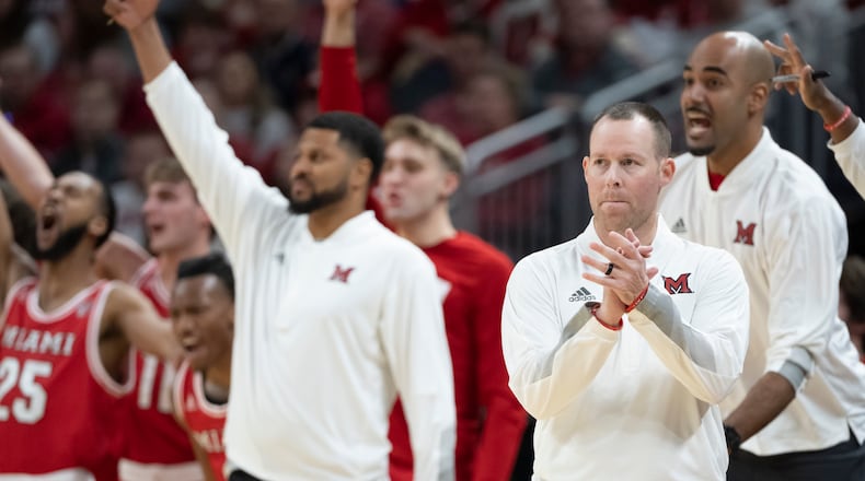 Miami (Ohio) head coach Travis Steele, front right, reacts during the first half of an NCAA college basketball game against Indiana, Sunday, Nov. 20, 2022, in Indianapolis. (AP Photo/Marc Lebryk)