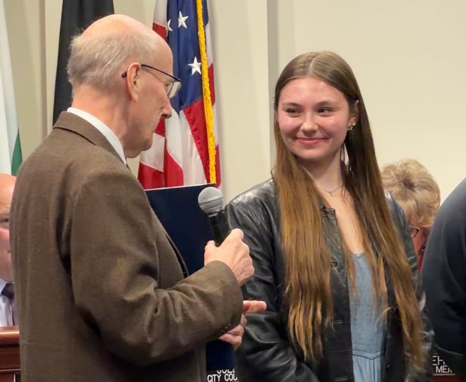 Hamilton Mayor Pat Moeller speaks to Hamilton High School senior Kaitlyn Roberts during a Hamilton City Council meeting Wednesday, Feb. 11, 2026. Roberts was honored by the city at the meeting for writing an essay that earned her a $20,000 scholarship in a Veterans of Foreign War competition. ERIC SCHWARTZBERG/STAFF