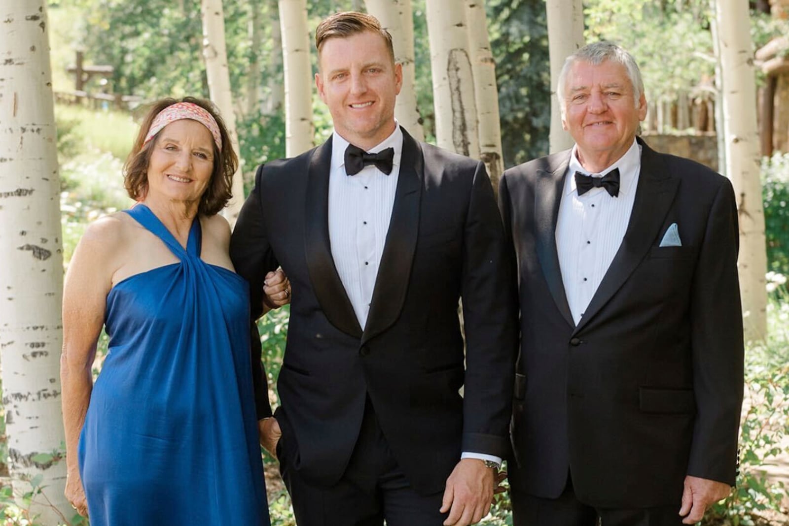 This undated photo provided by the Pickles family shows Josh Pickles, center, with his parents Terry Pickles, right, and mother Paula Bozinovich. (Pickles Family via AP)