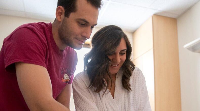 Newborn Eden Couch receives her first bath from parents, Tayna and Capt. Collin Couch, inside the family birthing section of the Wright-Patterson Medical Center. (U.S. Air Force photo/Michelle Gigante)