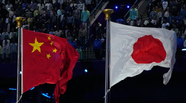 FILE - The flags of China and Japan are flown at the during the handover ceremony from China to Japan the next host of the Asian Games at the closing ceremony of the 19th Asian Games in Hangzhou, China, Sunday, Oct. 8, 2023. (AP Photo/Eugene Hoshiko, File)