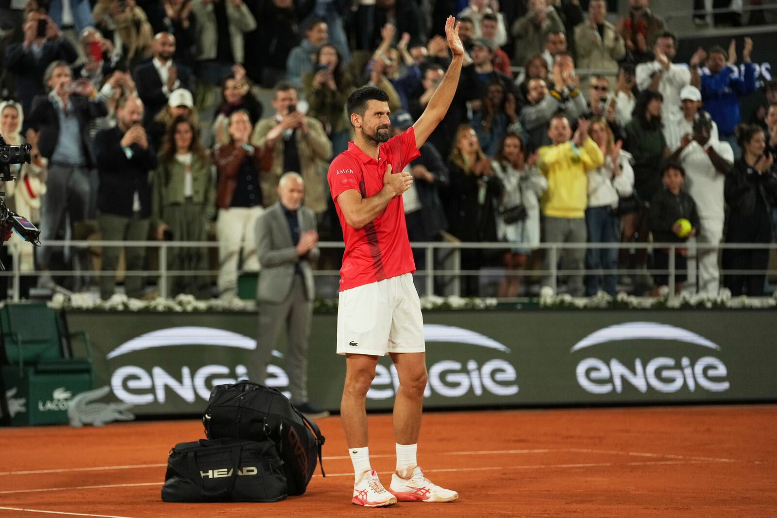Serbia's Novak Djokovic gestures as he leaves the semifinal match of the French Tennis Open against Italy's Jannik Sinner at the Roland-Garros stadium in Paris, Friday, June 6, 2025. (AP Photo/Thibault Camus)