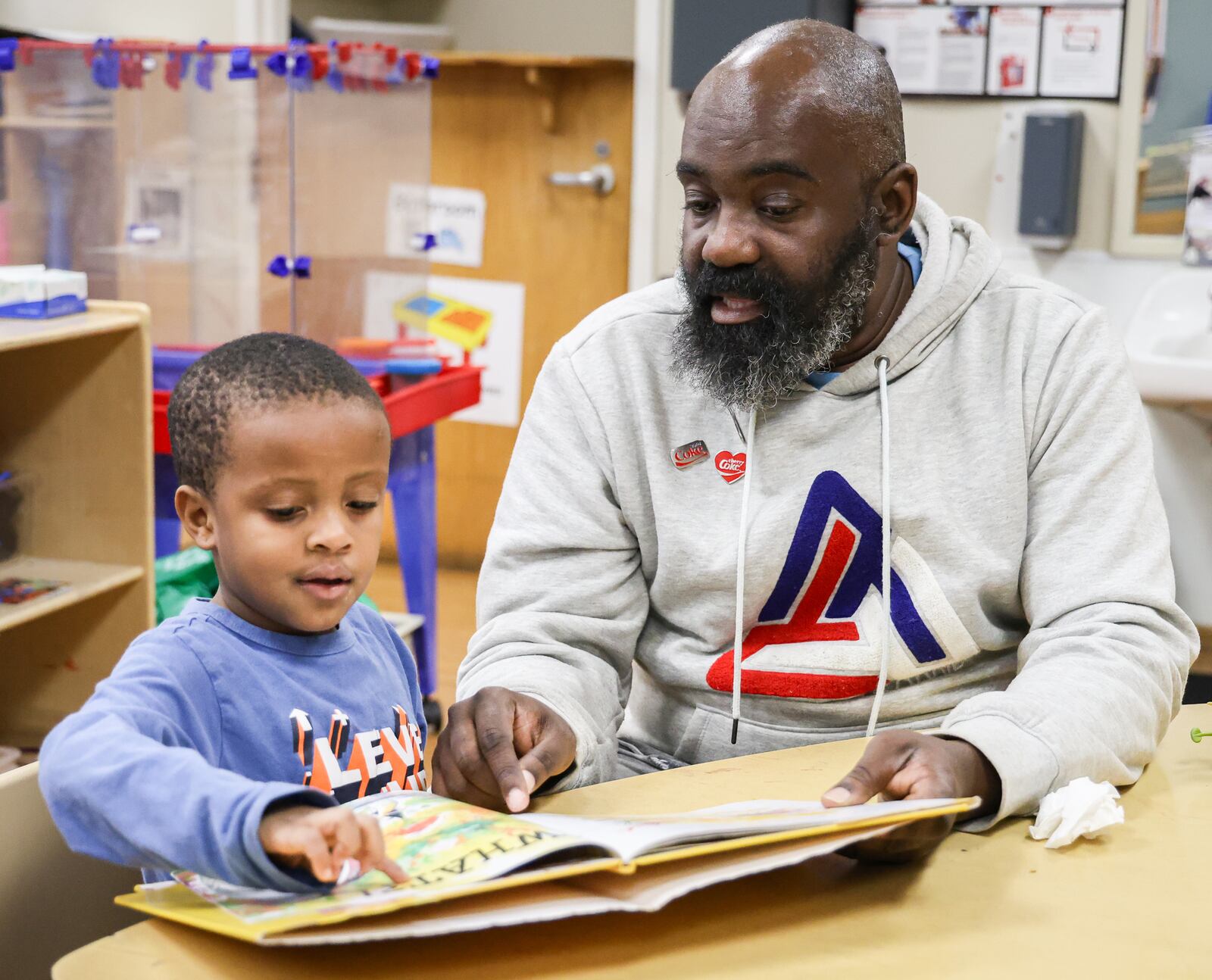 Jovan Etter reads to children in his classroom at Miami Valley Child Development Center in Trotwood on Tuesday. The White House budget proposal “does not fund Head Start,” according to the draft. The White House says eliminating the program is consistent with the Trump administration’s “goals of returning control of education to the states and increasing parental control.” BRYANT BILLING / STAFF